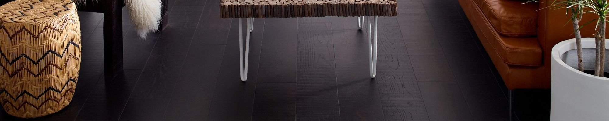 A table on a dark hardwood floor from Carpet Plus in the Worthington, MN area