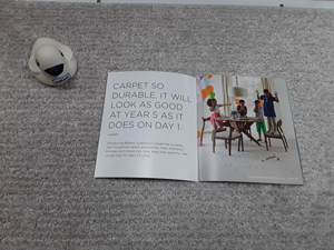 Book on gray carpet from Carpet Plus in the Worthington, MN area