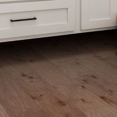 Basket of laundry in laundry room with engineered hardwood flooring from Carpet Plus in the Worthington, MN area