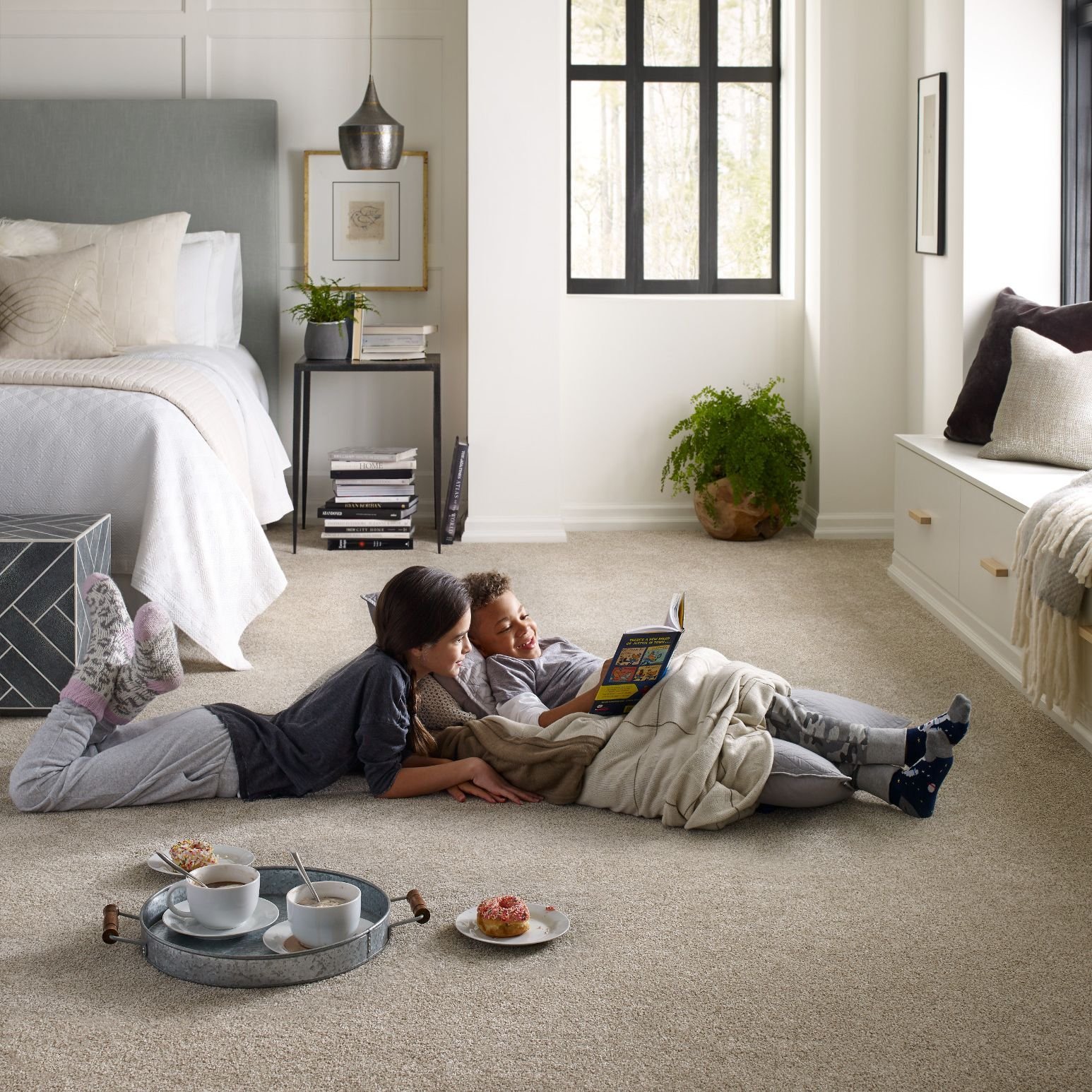 Kids reading on bedroom carpet from Carpet Plus in Worthington