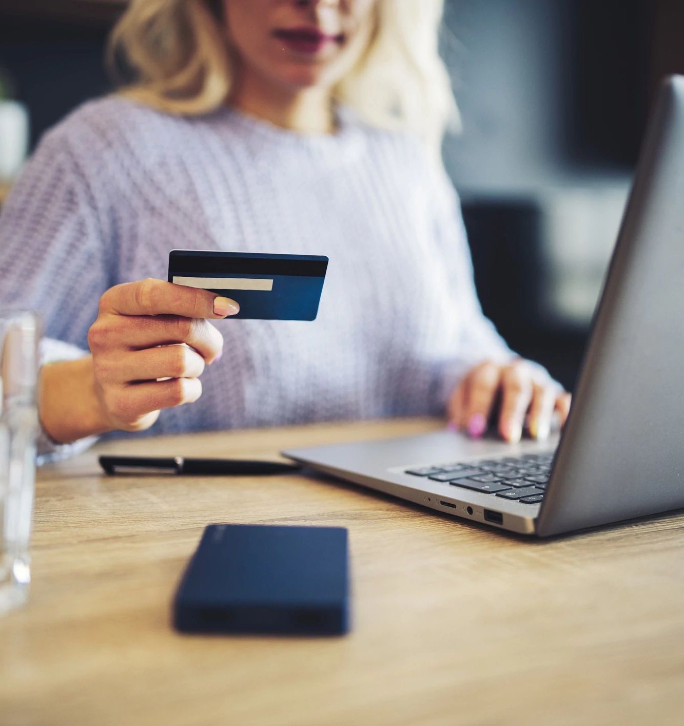 Person using a laptop to pay online by card - Quick and easy financing with approved credit via Synchrony from Carpet Plus in the Worthington, MN area